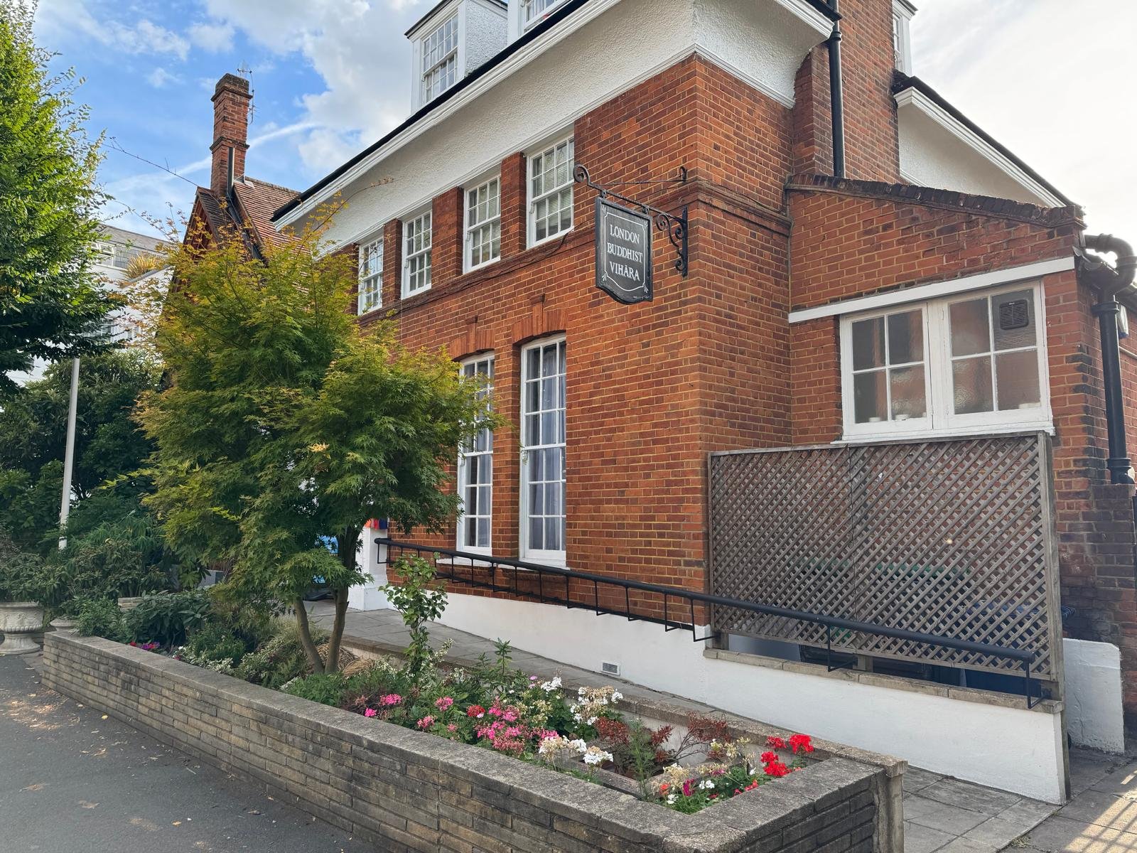 The London Buddhist Vihara building on The Avenue, Chiswick, with its hanging sign and the step-free ramp